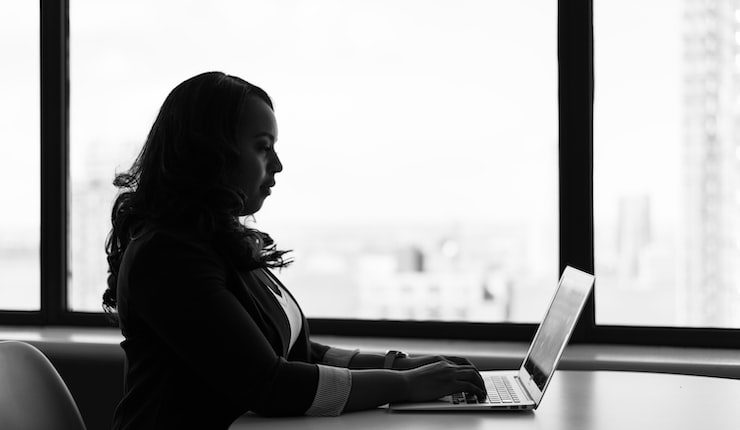 woman sitting and using laptop
