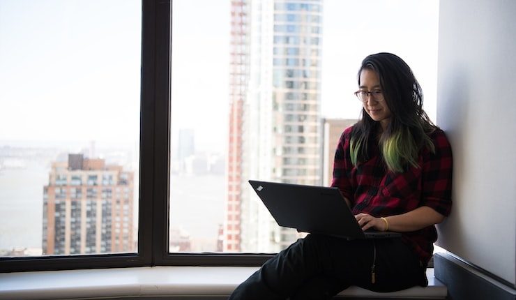 woman siting facing laptop computer