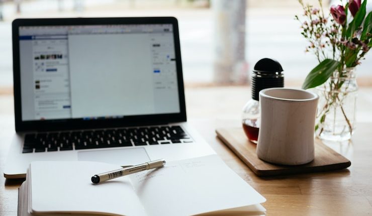 MacBook Pro near white open book