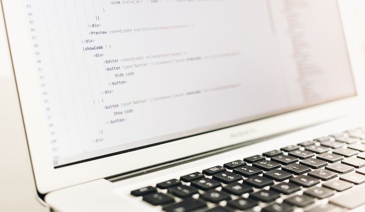 turned on MacBook Air displaying coding application