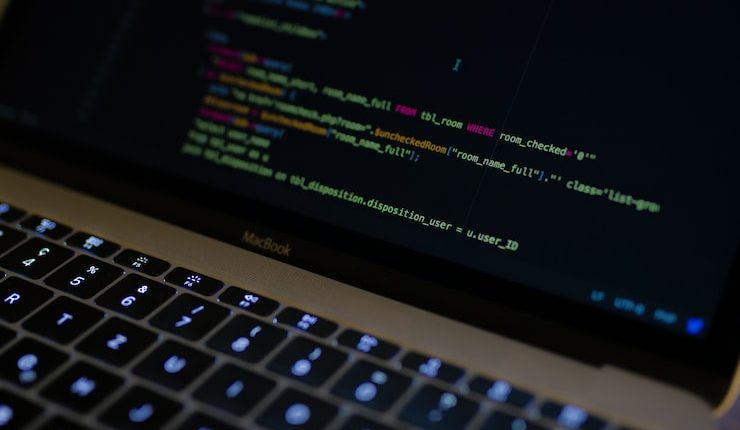 MacBook Pro with images of computer language codes